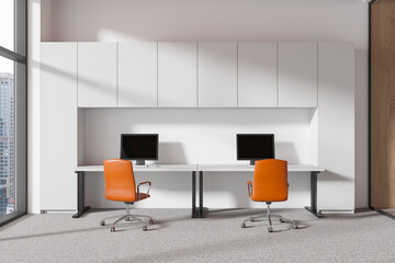 Office coworking interior with pc monitors and chairs, panoramic window