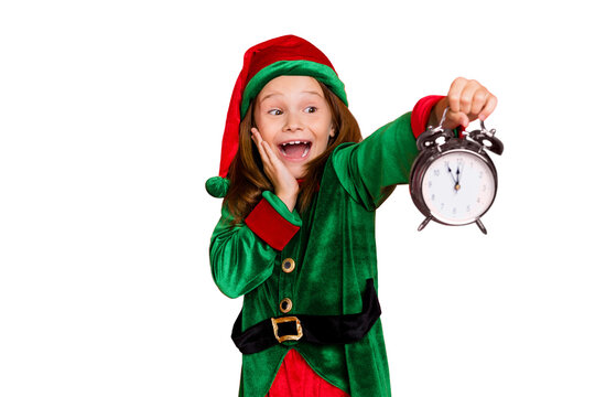 Close-up portrait of her she nice attractive cheerful cheery surprised shocked glad funny pre-teen elf holding in hands clock fairy miracle night isolated over bright vivid shine red background - Powered by Adobe