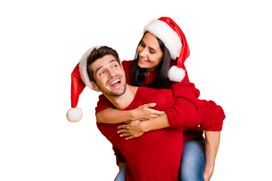 Portrait of cheerful man hug his wife piggyback wear red pullover isolated over yellow background