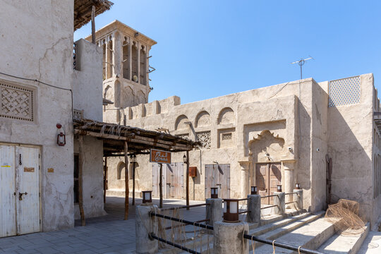 Dubai, UAE, 27.09.2021. Al Fahidi Historical District stone street with traditional buildings with arabic ornaments and a windcatcher, Deira, Dubai.