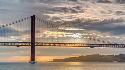 Obraz premium Lisbon city sunrise with April 25 bridge timelapse