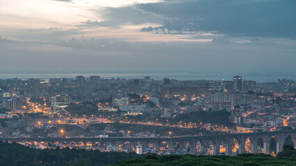 Panoramic view over Lisbon and Almada from a viewpoint in Monsanto night to day timelapse.