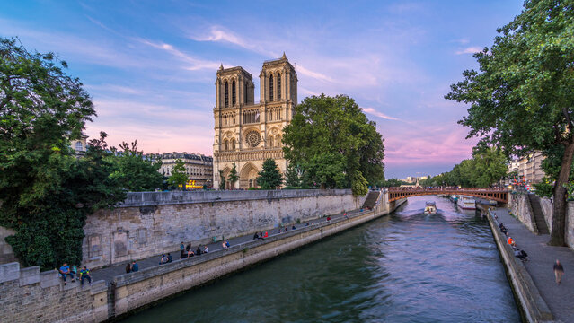 Front view of Notre Dame De Paris cathedral day to night timelapse after sunset.