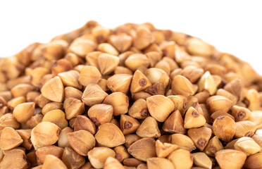 Raw buckwheat groats on a white background, macro.