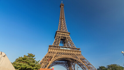 The Eiffel tower with warm light during sunset timelapse hyperlapse.