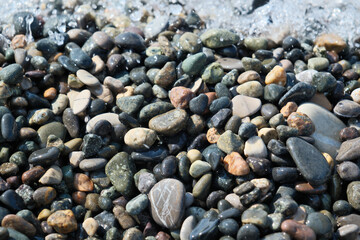 Colorful pebble stones on the beach, pebble stones on the seashore, closeup of photo