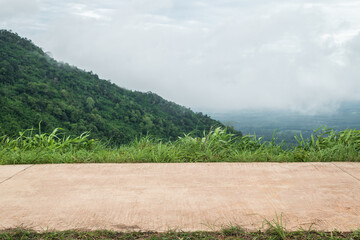 Side view of concrete road with meadow