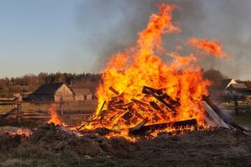 Flame and smoke from the fire. Burning garbage in the village. Big bonfire in the village....