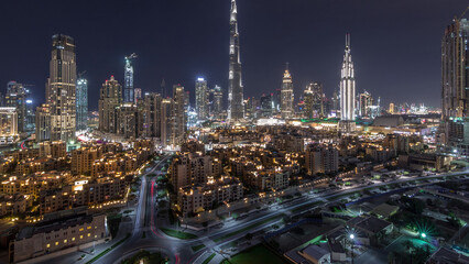 Fototapeta premium Dubai Downtown skyline night timelapse with Burj Khalifa and other towers panoramic view from the top in Dubai