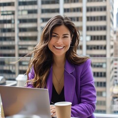 Young woman in purple blazer smiles while working on a laptop at a caf&eacute; with a city skyline view in the background, enjoying her coffee