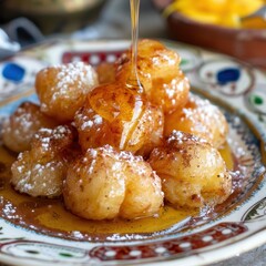 A serving of loukoumades, Greek honey puffs drizzled with honey and sprinkled with cinnamon, served on a decorative plate