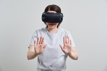 Happy young woman playing on VR glasses indoor, Virtual reality concept with young girl having fun with headset goggles, with copy space