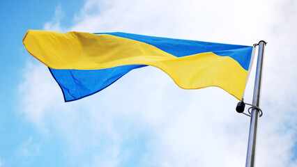 Ukrainian National Flag Unfurling Against Sky Backdrop