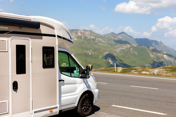 Scenic view big modern white family rv camper van vehicle drive Europe highway road alpine pass...