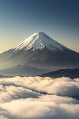 Fototapeta premium A distant snow-capped volcano rising above the clouds