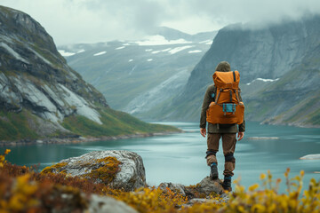 A man tourist backpacker, travel on mountain hills with cloudy day on holiday vacation.