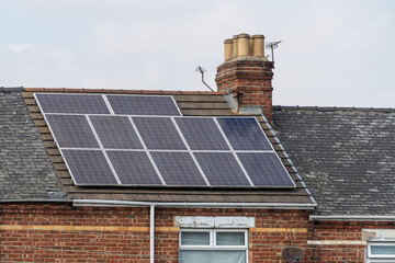 Solar panels on a terraced house roof. Concept of household or home solar energy generation.