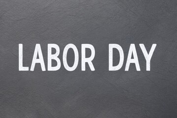 Obraz premium Gray background with word labor day.