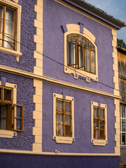 Uphill view on empty Sighisoara street with colorful medieval houses, Romania