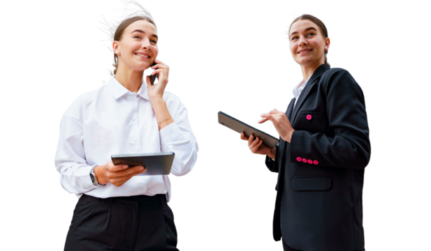 A young professional woman, confident and smiling, multitasking with a phone and tablet