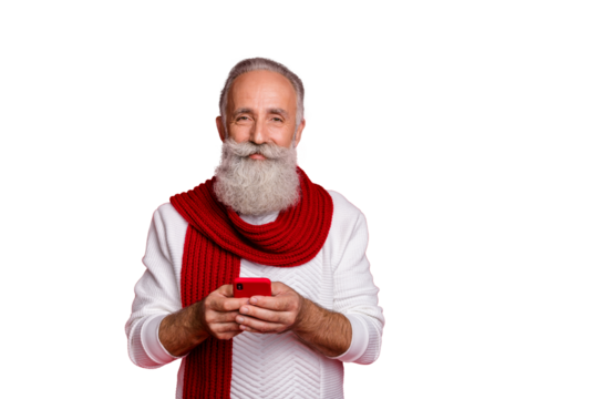 Portrait of his he nice attractive cheerful cheery peaceful gray-haired man holding in hands using cell internet online web 5g connection speed isolated over bright vivid shine red background