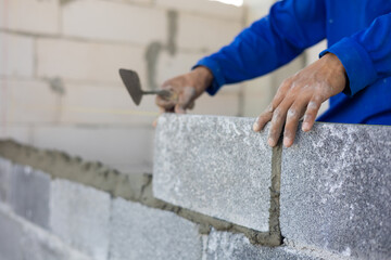 Close up hand construction mason worker bricklayer Engineering people, man construction worker and architecture bricklayers working in work at house construction site. Caucasian men