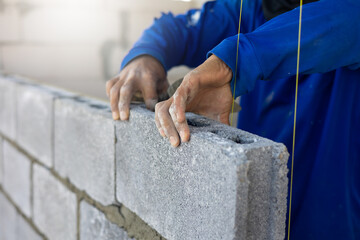 Close up hand construction mason worker bricklayer Engineering people, man construction worker and architecture bricklayers working in work at house construction site. Caucasian men