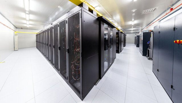 Network servers in a data center. Tier III carrier neutral data center. Server rooms.