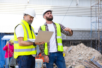 Two Professional Architects Engineer Working on Personal laptop computer at house construction site. Product quality Inspection