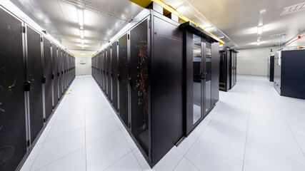 Network servers in a data center. Tier III carrier neutral data center. Server rooms.