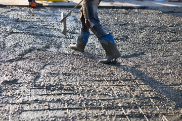 wet concret. Engineering people, construction site. mason worker pouring the ready-mixed concrete...
