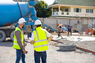 wet concret. Engineering people, construction site. construction worker  and architecture pouring wet concret in road construction site. Caucasian men