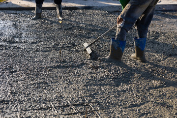 wet concret. Engineering people, construction site. mason worker pouring the ready-mixed concrete...