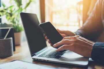 Fototapeta premium Hands of a businesswoman typing on a laptop computer on a desk in the office