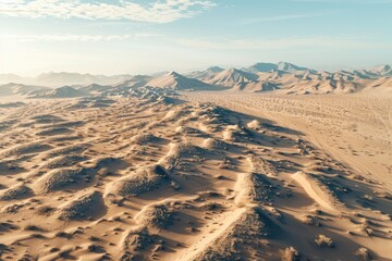 Aerial View of Expansive Desert Landscape with Rolling Sand Dunes and Distant Mountains