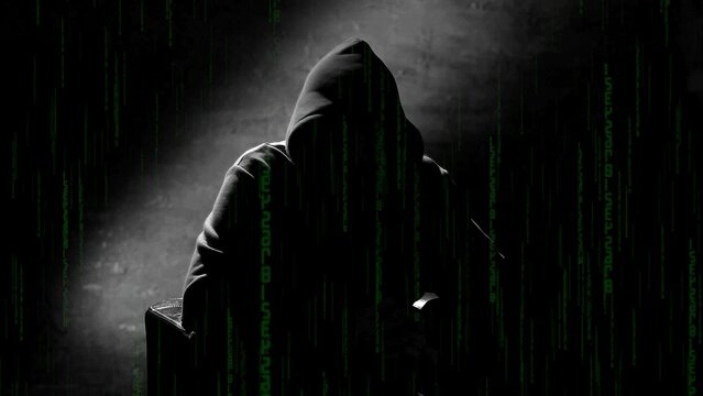 Anonymous man in a hood interview background, mysterious man sitting on a chair and talking. Anonymous hacker interview with no visible face, computer hacker conceptual background