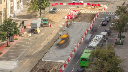 The bulldozer moves and spreads the soil and rubble on the road timelapse.