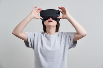 Happy young woman playing on VR glasses indoor, Virtual reality concept with young girl having fun with headset goggles, with copy space