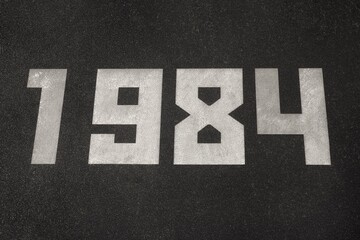 A black granite slab with white numbers 1984 on it