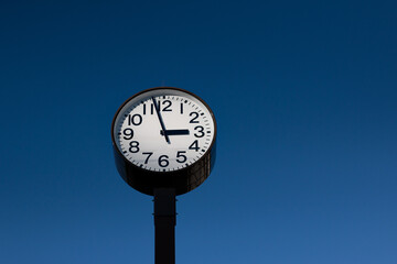Classic Clock Tower Against Clear Blue Sky at Noon