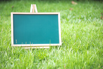 Empty Chalkboard on Lush Green Grass Ready for Custom Message