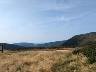 Beautiful mountain view with clear skies and a small field