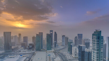 Obraz premium Skyscrapers at sunset timelapse in the skyline of commercial center of Doha, the capital Qatar