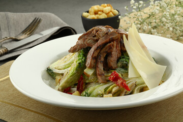 Refreshing salad with tender chunks of tuna, beef, chicken mixed greens, and crisp vegetables. Lightly dressed with a zesty vinaigrette, offering a healthy and flavorful meal option.