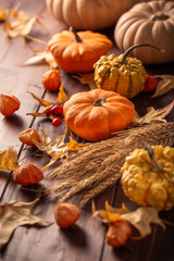 Thanksgiving home decoration, autumn still life with pumpkins and leaves on wooden background