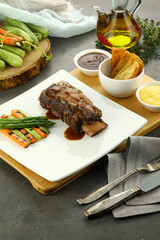 Grilled beef steak served with tender asparagus spears. The juicy steak, charred to perfection, pairs beautifully with the crisp, lightly seasoned asparagus for a balanced, flavorful meal.