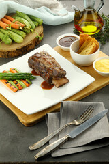 Grilled beef steak served with tender asparagus spears. The juicy steak, charred to perfection, pairs beautifully with the crisp, lightly seasoned asparagus for a balanced, flavorful meal.