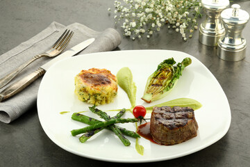 Grilled beef steak served with tender asparagus spears. The juicy steak, charred to perfection, pairs beautifully with the crisp, lightly seasoned asparagus for a balanced, flavorful meal.