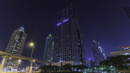 Naklejka premium Skyscrapers at the Sheikh Zayed Road night in Dubai timelapse hyperlapse