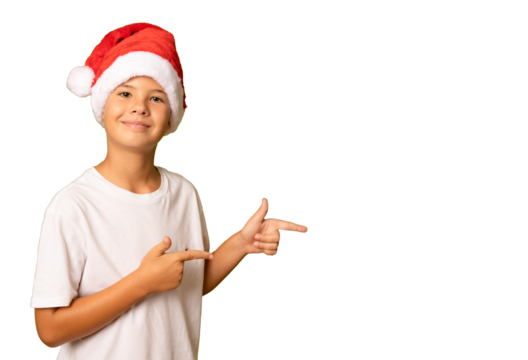 Portrait of a surprised boy in a red hat and white t-shirt pointing fingers side on a transparent background. A child in a Christmas hat of Santa Claus. - Powered by Adobe